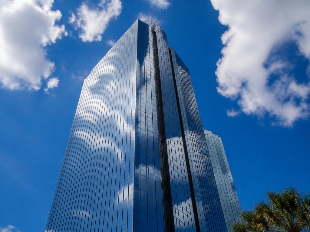 Tall modern glass office tower requiring specialized access